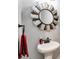 Powder room with pedestal sink and unique windmill mirror at 350 Taylor Path, Dallas, GA 30157
