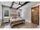 Main bedroom with hardwood floors, exposed beams, and a barn door at 350 Taylor Path, Dallas, GA 30157