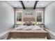 Main bedroom with wood beams, a barn door, and large windows at 350 Taylor Path, Dallas, GA 30157