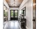Light and airy entryway with hardwood floors and black doors at 350 Taylor Path, Dallas, GA 30157