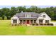 White farmhouse with red door, gray roof and landscaping at 350 Taylor Path, Dallas, GA 30157