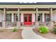 Inviting front porch with red door, rocking chairs, and brick columns at 350 Taylor Path, Dallas, GA 30157