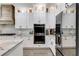 White kitchen with stainless steel appliances and wooden range hood at 350 Taylor Path, Dallas, GA 30157