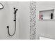 Close-up of shower with pebble tile accent and fixtures at 350 Taylor Path, Dallas, GA 30157