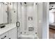 Walk-in shower with pebble tile accents and glass enclosure at 350 Taylor Path, Dallas, GA 30157