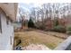 Large backyard with a wooden fence and mature trees at 3844 Davis St, Suwanee, GA 30024