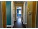 Long hallway with dark hardwood floors and blue walls at 3844 Davis St, Suwanee, GA 30024