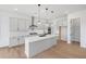 Modern kitchen with white cabinets, quartz countertops, and island at 6315 Wallace Farms Dr, Cumming, GA 30028