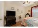 Bedroom with a queen-size bed and decorative wall art at 303 Breezy Hill Walk, Stockbridge, GA 30281