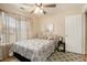 Bedroom with a queen bed, ceiling fan, and decorative pillows at 303 Breezy Hill Walk, Stockbridge, GA 30281