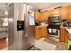Kitchen with stainless steel refrigerator and wood cabinets at 303 Breezy Hill Walk, Stockbridge, GA 30281