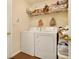 Washer and dryer in a functional laundry room with extra shelving at 303 Breezy Hill Walk, Stockbridge, GA 30281