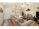 Bright living room featuring a sectional sofa and ceiling fan at 303 Breezy Hill Walk, Stockbridge, GA 30281