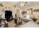 Living room with sectional sofa and large TV at 303 Breezy Hill Walk, Stockbridge, GA 30281