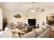 Spacious living room with comfortable seating and a fireplace at 303 Breezy Hill Walk, Stockbridge, GA 30281