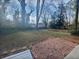 Large backyard with brick patio and mature trees at 2268 Turtle Club Ne Dr, Marietta, GA 30066