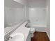 A well-lit bathroom featuring a single sink, bathtub, toilet, and a large mirror at 2268 Turtle Club Ne Dr, Marietta, GA 30066