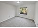 Well-lit bedroom featuring grey carpeting and a window at 2268 Turtle Club Ne Dr, Marietta, GA 30066