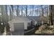 View of the home with an attached garage, surrounded by trees at 2268 Turtle Club Ne Dr, Marietta, GA 30066
