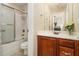 Clean bathroom with a shower/tub combo and wood vanity at 4851 Planters Walk, Douglasville, GA 30135