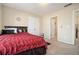 Bedroom with red bedding, double closet, and access to a shared bathroom at 4851 Planters Walk, Douglasville, GA 30135
