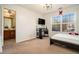 Bright bedroom with ensuite bathroom access, featuring a large window and neutral carpeting at 4851 Planters Walk, Douglasville, GA 30135