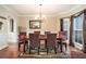 Elegant dining room with hardwood floors, a chandelier, and bay window at 4851 Planters Walk, Douglasville, GA 30135