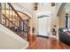 Two-story entryway with hardwood floors, staircase and a view of the living room at 4851 Planters Walk, Douglasville, GA 30135