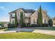 Charming two-story brick home featuring manicured landscaping and a welcoming front entrance at 4851 Planters Walk, Douglasville, GA 30135