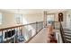 Open upper hallway overlooking living room with chandelier and neutral carpeting at 4851 Planters Walk, Douglasville, GA 30135