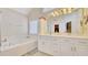 Bathroom with double vanity, soaking tub, and bright lighting at 729 River Bridge Dr, Lawrenceville, GA 30046