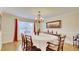 Formal dining room with hardwood floors, chandelier, and oval dining table at 729 River Bridge Dr, Lawrenceville, GA 30046