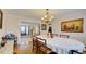 Bright dining room with hardwood floors, chandelier, and view to living room at 729 River Bridge Dr, Lawrenceville, GA 30046