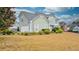 Two-story house with a side view showcasing a boat, landscaping, and a two-car garage at 729 River Bridge Dr, Lawrenceville, GA 30046