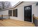 New wooden deck with black railings next to the front entrance at 1326 Elm Cir, Stockbridge, GA 30281