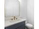 Powder room with navy vanity, white countertop and gold fixtures at 3921 Enclave Way, Tucker, GA 30084