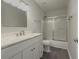 Bathroom with white vanity, marble countertop, and tub/shower combo at 601 Ashton Ln, Lawrenceville, GA 30044