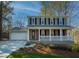 Two-story house with a brick facade, white porch, and a two-car garage at 601 Ashton Ln, Lawrenceville, GA 30044