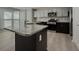 Island kitchen features granite countertops and stainless steel appliances at 601 Ashton Ln, Lawrenceville, GA 30044