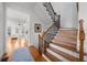 Elegant staircase with wrought iron balusters and hardwood treads at 2022 Heathermere Way, Roswell, GA 30075