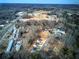 Scenic aerial view of a neighborhood showcasing the community's layout and proximity to schools and wooded areas at 96 Rome St, Temple, GA 30179
