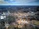 Another aerial view of the new home construction featuring a wooded area and nearby railroad tracks at 96 Rome St, Temple, GA 30179