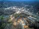 Final aerial view of the homes and development featuring wooded surroundings and lush greenery at 96 Rome St, Temple, GA 30179