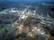 Final aerial view of the homes and development featuring wooded surroundings and lush greenery at 96 Rome St, Temple, GA 30179