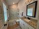 Well-lit bathroom with granite countertops, a framed mirror, and a marble-tiled walk-in shower at 96 Rome St, Temple, GA 30179