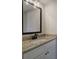 A bright and stylish bathroom features granite countertops and updated lighting fixtures at 96 Rome St, Temple, GA 30179