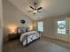 Charming bedroom featuring a wrought iron bed frame, ceiling fan, and light neutral paint at 96 Rome St, Temple, GA 30179