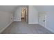Cozy neutral attic bedroom with angled ceilings features soft carpet and trim throughout the room at 96 Rome St, Temple, GA 30179