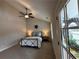 Bright bedroom features vaulted ceilings, a ceiling fan, and a view of the porch at 96 Rome St, Temple, GA 30179