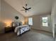 Charming bedroom featuring a wrought iron bed frame, ceiling fan, and a door to the porch at 96 Rome St, Temple, GA 30179